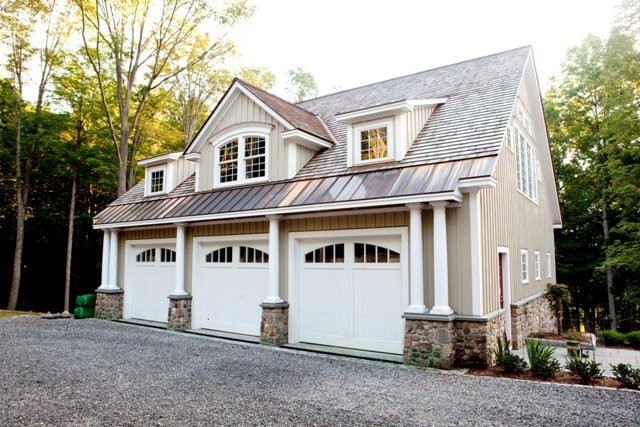 Carriage house plans: Carriage house plan exterior with three garage bays and living quarters on the upper level | Monster House Plans