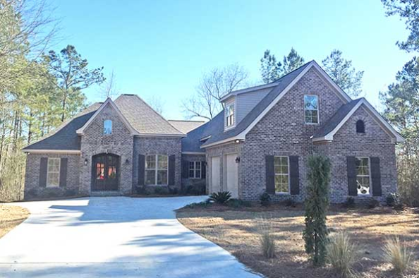 French Country house plans: French Country house plan exterior with a brick facade, hipped roof, and arched front | Monster House Plans