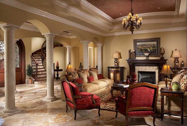 Florida house plans: Florida house plan interior living room with columned openings and a fireplace | Monster House Plans