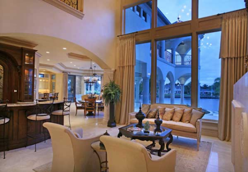 Mediterranean house plans: Mediterranean house plan interior living room with two-story arched windows and an open | Monster House Plans