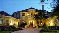 Spanish house plans: Spanish style house plan exterior with stucco walls, a clay tile roof, and arched entry | Monster House Plans