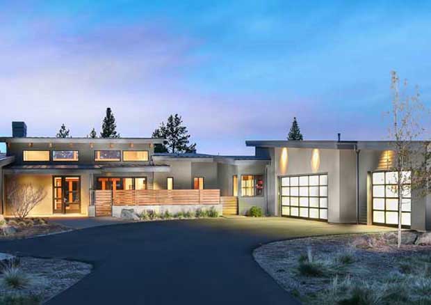 House plans - Modern house plan exterior lit at dusk with glass garage doors and a curved driveway | Monster House Plans