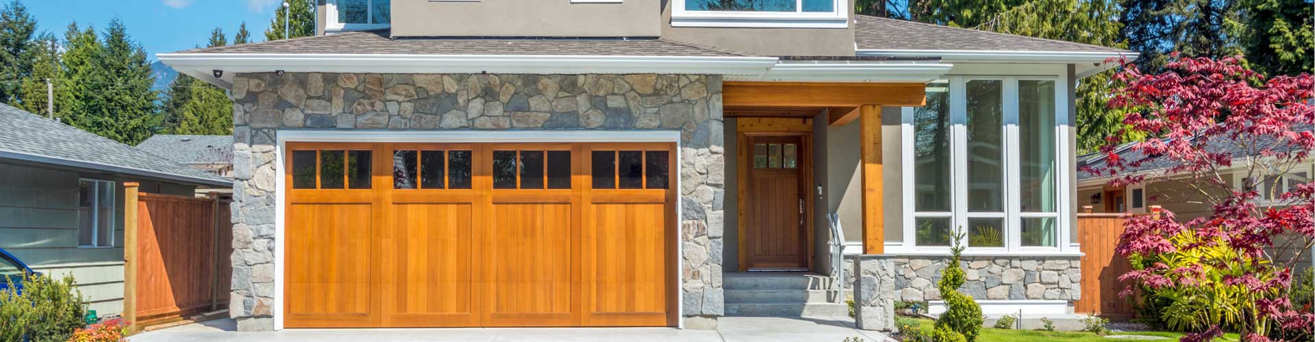 House plans - House plan exterior detail showing a wood carriage-style garage door and stone trim | Monster House Plans